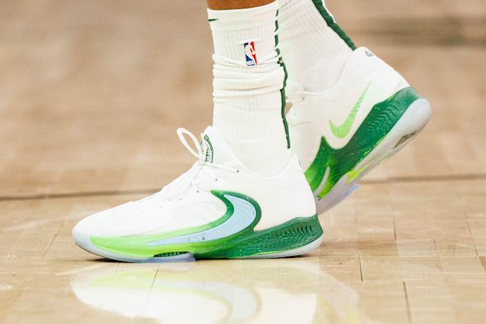View of Giannis Antetokounmpo's white and green Nike shoes.